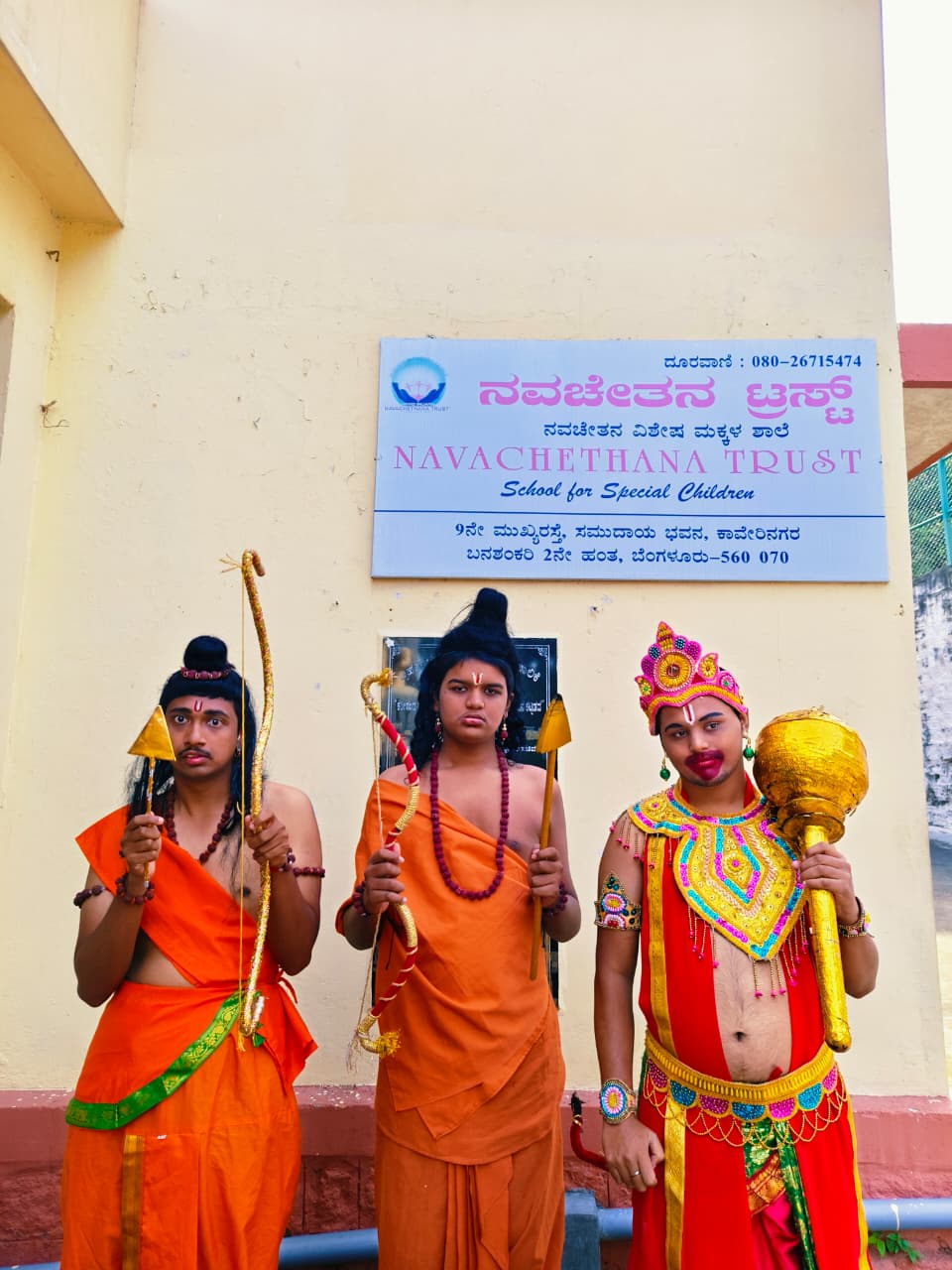 Students in traditional role-play costumes standing outside Navachethana Trust